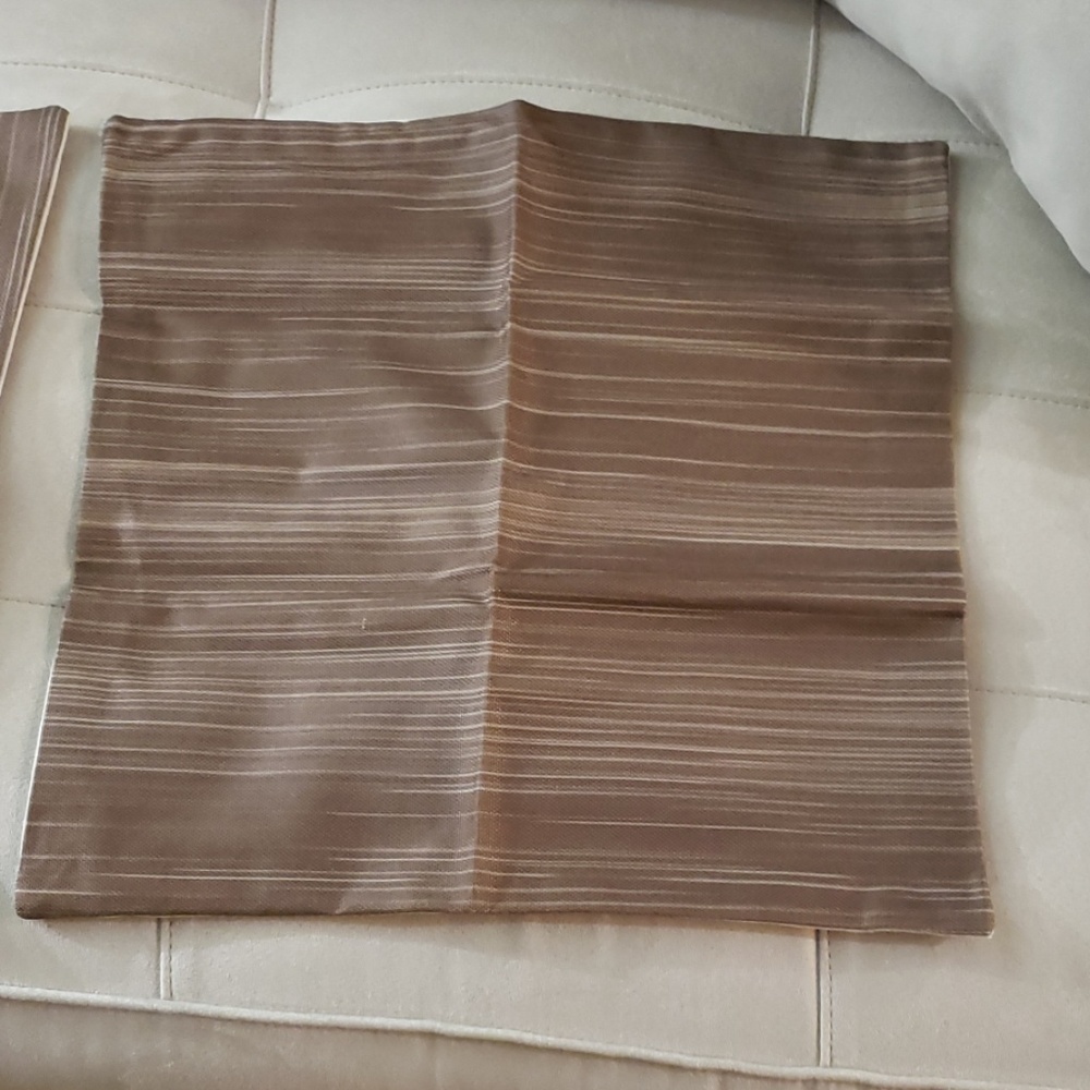 Two, dark brown and tan pillowcases